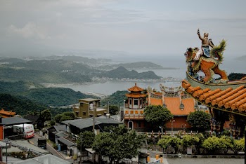 Houses Near Temple Viewing Body of Water