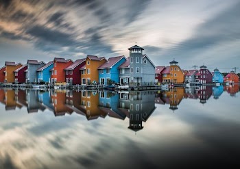 houses reflecting on body of water