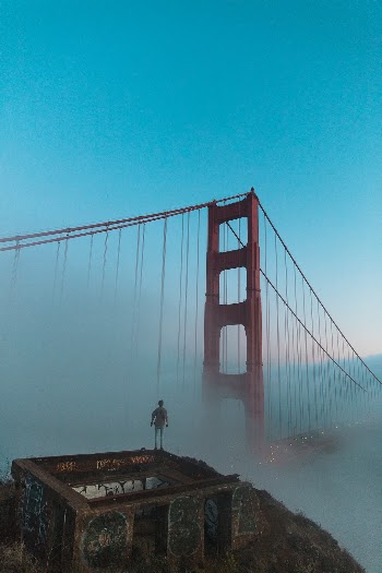 Huper Photos - Joshua Earle standing before the Golden Gate Bridge.