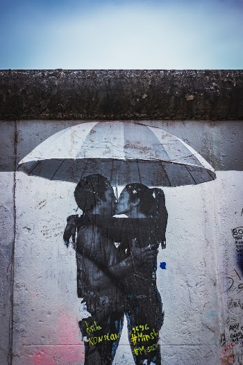 I found this street art of a couple embracing under an umbrella in a city that was once divided by the wall that its on to be great symbol for the coming together that finally occurred.