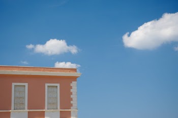 I love clouds. In this picture I like the contrast between complementary colors and between the geometric lines of the building and the smooth and fluffy white clouds 