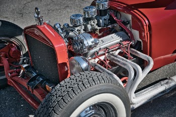 I love the simpleness of the classic hotrods.  Who needs things like covers of the engine when there is so much cool stuff to see.  I like how this photo is very mechanical with all the parts and shinny thing it keeps your eyes moving.