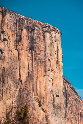 I was hiking around Yosemite and photographing with a variety of lenses. I took several shots with a 28mm f2 and some with my 50mm f1.8. It seemed I was capturing good pictures but all of them only slightly deviated from the typical pictures you see of these colossal rocks. On whim I pulled out my dad’s old 200mm Minolta Rokkor telephoto lens that used in the 1970s with his XD11. I started shooting with this heavy old lens and quickly became obsessed with the details and colors it showed. Somehow a lens with a narrower field of view helped show just how giant and beautiful El Capitan is.