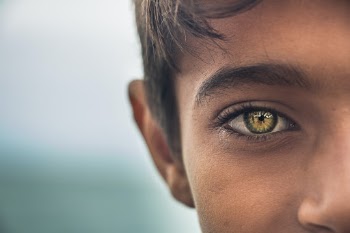 I was on a trip to Hormoz island then a boy came to me and tried to sell his huge seashell. When I looked deeply to his beautiful face, I've noticed he has a stunning eyes. So I asked him to let me shoot his eyes plus I bought him a Coca.
Then this photo has been created.