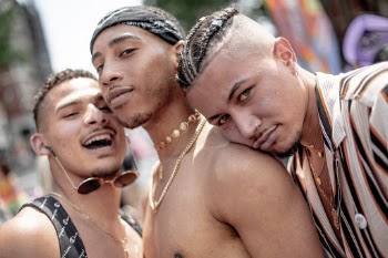 I was walking around at Pride 2019 in New York to portrait interesting people and scenes. 

The boys were having a party in the middle of the street. I ended up taking a lot of photos of them and all their friends. I like this the most because of the three very different expressions and stories their faces tell.  
