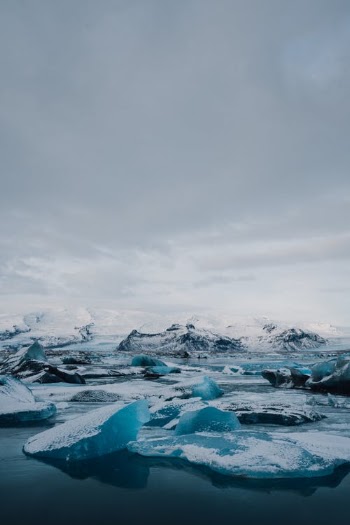 Ice on Body of Water Under Cloudy Sky · Free Stock Photo