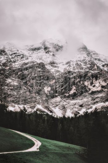 icy mountain under white clouds