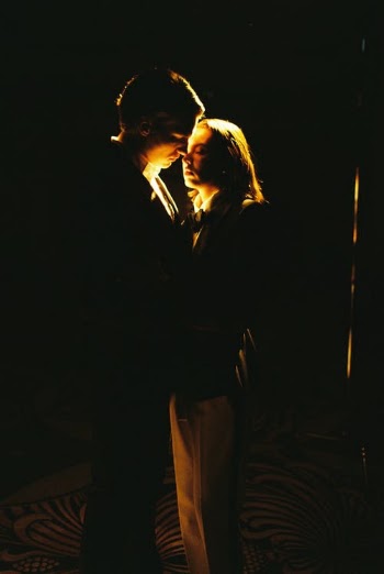 Illuminated Man and Woman Standing Face to Face in Darkness · Free Stock Photo