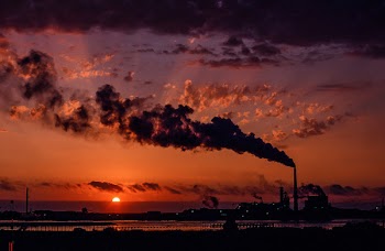  Industrial factory smoke from smokestacks over sunset sky 