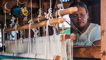 Inle lake, Shan State, Myanmar * November,1,2017 : The lIntha woman weaving the lotus cloth with the hand loom at the local lotus cloth weaving factory. Selective focused