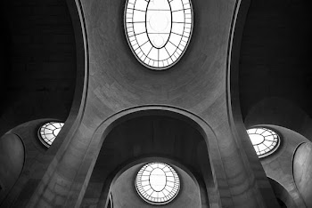 interior building with glass window at the roof grayscale photography