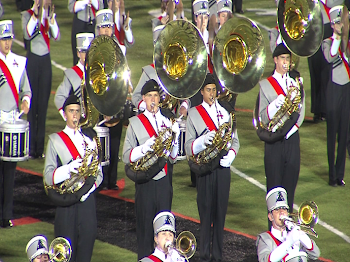 Iowa marching band students walk away during national anthem