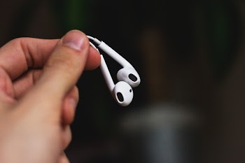 iPhone headphones in a male hand