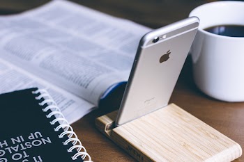 iPhone in a wooden phone holder 2