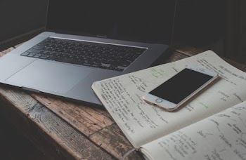 Iphone on Notebook Beside Laptop