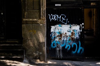 Iron black door with graffiti.