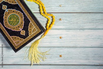 Islamic Concept - Holy Quran on Wooden Background. Shallow depth of field
