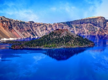 Island on Blue Water Surrounded by Moutain