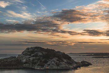 Island Surrounded by the Sea Under Stratus Clouds