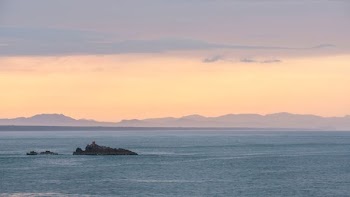 islet on sea during daytime