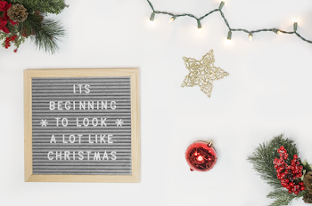 It's Beginning to Look a Lot Like Christmas Board Decor Beside Star and Red Bauble Flatlay Photography