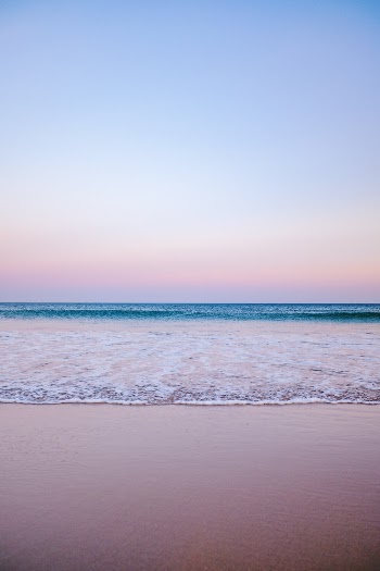 It was a beautiful but windy evening, with small waves rolling in. The off-shore wind made for long peeling waves, and the incoming mist made the nightsky a lush gradient of warm pink and purplish blue hues.  