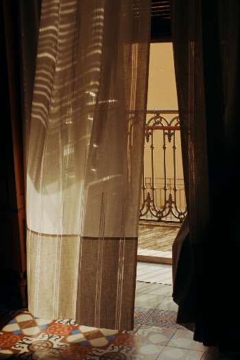 Italy interior vintage tiles and balcony with open window and linen fabric curtain