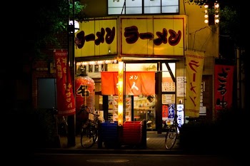 Japanese store with signage and two bicycle parked outside