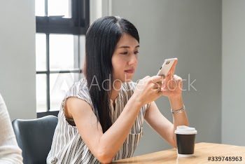 Japanese woman playing on her phone