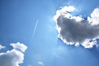Jet Stream And Sun Behind Clouds