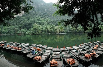 jon boats on river surrounded by trees
