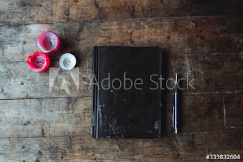 Journal on a wooden table in a forest cabin