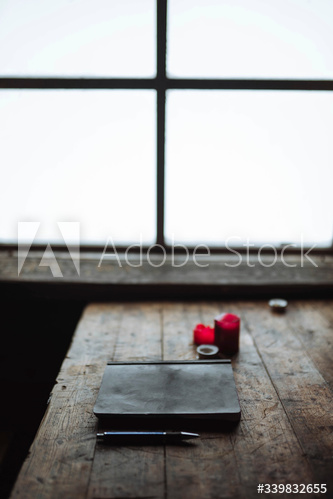Journal on a wooden table in a forest cabin