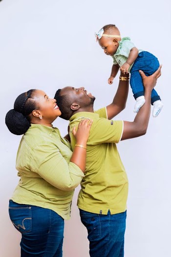 Joyful Family Moment: Parents Playing with Their Child