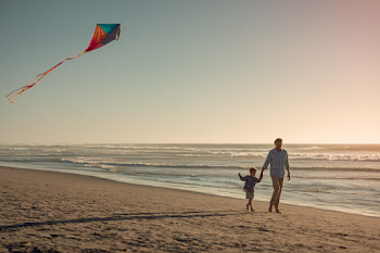 Joyful Father and Son Kite Flying on a Beach