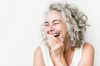 Joyful Middle-Aged Woman Laughing in Studio Portrait