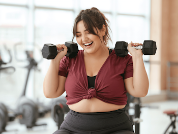 Joyful Plus-Size Woman Exercising in Modern Gym