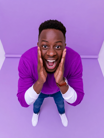 Joyful Young Black Man in Purple Sweater
