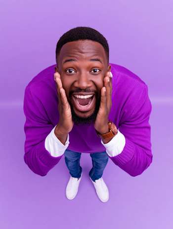Joyful Young Black Man Shouting in Studio Portrait