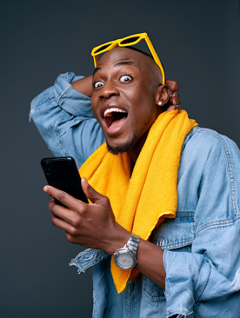Joyful Young Black Man with Smartphone