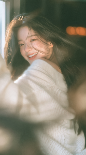 Joyful Young Woman in Knit Sweater by Window