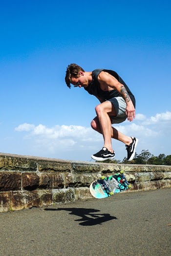 Jumping Man Together With Blue Skateboard