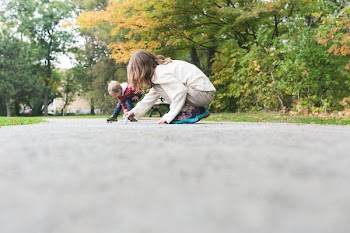 Kids Draw With Chalk On Sidewalk
