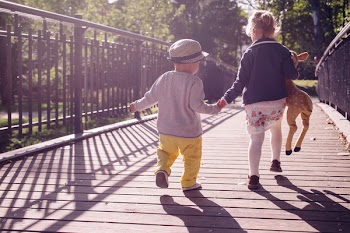 Kids running across the bridge