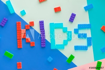 Kids spelled word with plastic blocks background