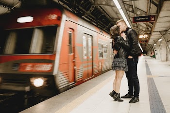 Kissing Couple Beside Running Train in Subway