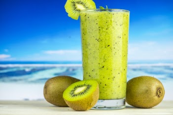 Kiwi Fruit Beside Drinking Glass Filled With Kiwi Shake