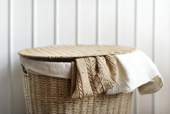 Knitted clothes in a rattan | Free Photo - rawpixel