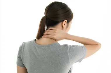 Korean Woman Touching Neck in Casual Attire Korean Woman Touching Neck in Casual Attire
