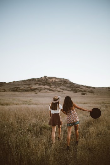 ladies walking through grass field, | Free Photo - rawpixel
